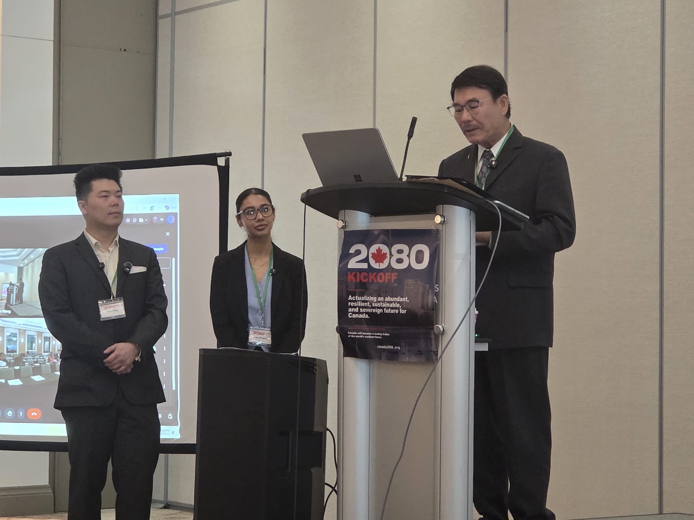 Alan Ho at the podium during the Canada2080 kickoff in the Markham Ballroom, 4 October 2026.